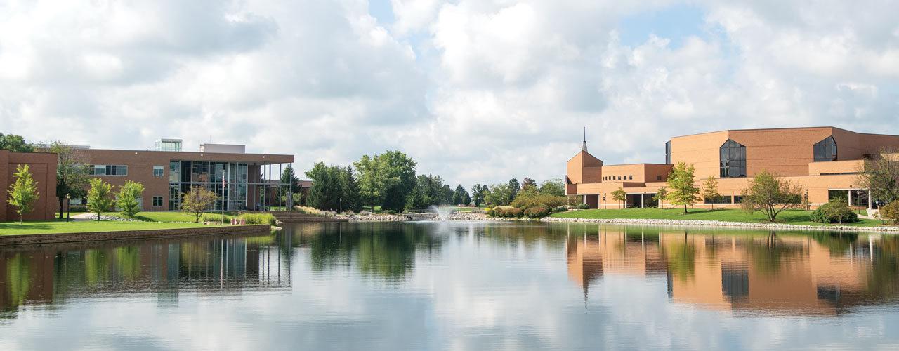 Image of Cedarville campus: Dixon ministry center, Cedar-lake and Biblical and Theological Studies Center are shown on a clear summer day